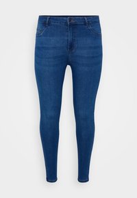 Skinny jeans made of dark blue denim. Features a fitted cut, five-pocket design, and subtle fading on the front surface.