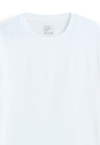 White cotton t-shirt with a crew neckline and short sleeves, featuring a small logo label in the center of the neck area.