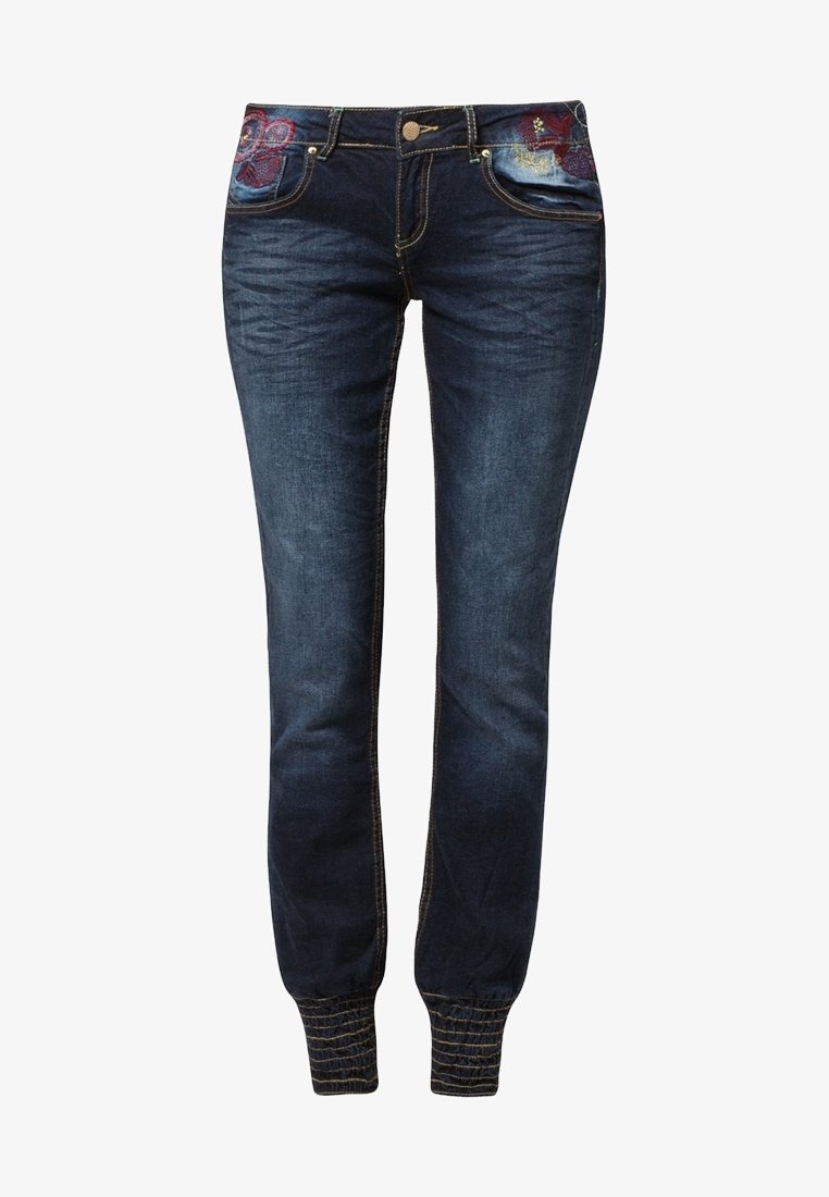 Tmavě modré džíny jogger s elastickými manžetami, květinovou výšivkou na předních kapsách a páskem se zapínáním na knoflík.