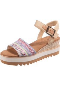 Platform sandals with a woven strap featuring multicolored geometric patterns, beige ankle strap, and textured natural sole with serrated edge.