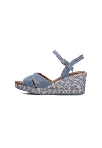 Blue denim wedge sandals with crossed straps, adjustable ankle strap, and woven jute-like midsole featuring a striped pattern.