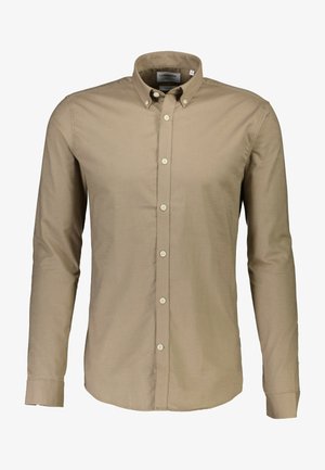 Beige gombos ing pamutanyagból, széles gallérral, hosszú ujjakkal és enyhén ívelt hemnél. Klasszikus gombzár az elején.