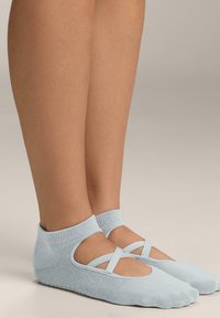 Light blue textile ballet socks featuring a cross-strap design, ankle-length, with a soft texture and a snug fit around the foot.