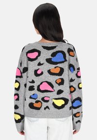 Maglione grigio con motivi a cuore texturizzati e a macchie di leopardo colorati in rosa, blu, arancione e giallo. Vestibilità casual, maniche lunghe, collo rotondo.