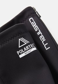 Czarna tkanina z białym logo Polartec AirCore oraz widoczną nazwą marki Castelli na szytym, zapinanym na zamek odzieży rowerowej.