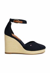 Navy canvas wedge heel with a textured natural rope platform, featuring an ankle strap with a brown leather buckle and small logo detail.