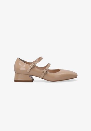 Beige patent leather Mary Jane shoes with a pointed toe, two adjustable straps, and a low block heel featuring a geometric design.