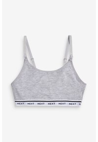 Sutien sport gri din bumbac, cu bretele subțiri ajustabile și o bandă albă pe care scrie "NEXT" în negru. Textură netedă, fără pernuțe.