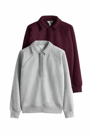 Dwie bluzy z kołnierzem, jedna jasnoszara z przodu i jedna ciemny bordo z tyłu, obie z długim rękawem i minimalnymi detalami szwów.