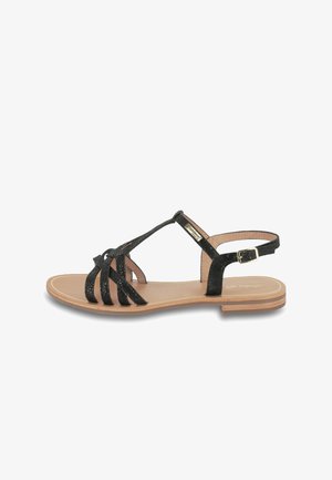 Black strappy sandals with glittery texture, featuring a flat heel and adjustable ankle strap. Smooth insole and minimalistic design.