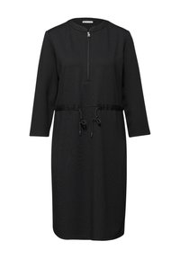 Schwarzes Kleid mit rundem Ausschnitt, 3/4-Ärmeln, Frontreißverschluss und Kordelzug in der Taille. Glattes Material mit leichter Struktur.