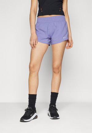 Light purple athletic shorts with a stretchy waistband and side pockets, paired with black shoes and crew socks.