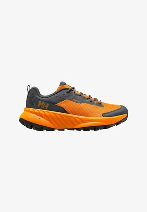 Zapatilla deportiva naranja y gris oscuro con suela negra, cuello acolchado, cierre de cordones en la parte delantera y marca en el lateral y talón.