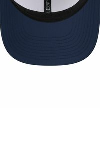 Navy blue baseball cap brim with black inner lining and a visible label tag inside the cap's crown.
