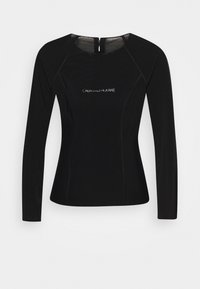 Czarny top z długim rękawem wykonany z elastycznego materiału, z okrągłym dekoltem, zamek błyskawiczny z tyłu oraz białym logo "CALVIN KLEIN JEANS".
