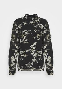 Blouse noire à manches longues avec imprimé floral blanc et vert clair, dotée d'un col montant avec une petite fermeture par bouton au dos.