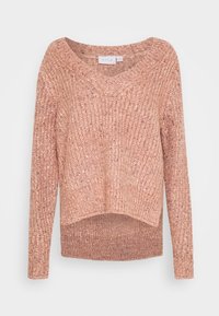 Tröja i mjukt, texturerat stickat material med V-ringning, långa ärmar och ojämn nederkant. Färgen är ljusrosa med subtila variationer.