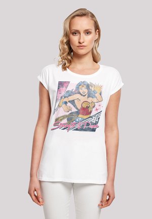 White cotton t-shirt featuring a colorful graphic of Wonder Woman, including text "Strength & Power," with a round neckline and short sleeves.