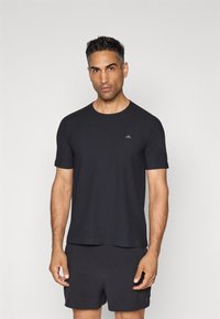 Schwarzes T-Shirt mit kurzen Ärmeln aus strukturiertem Stoff und Rundhalsausschnitt. Verfügt über ein kleines Logo auf der Brust und einen lässigen Schnitt.