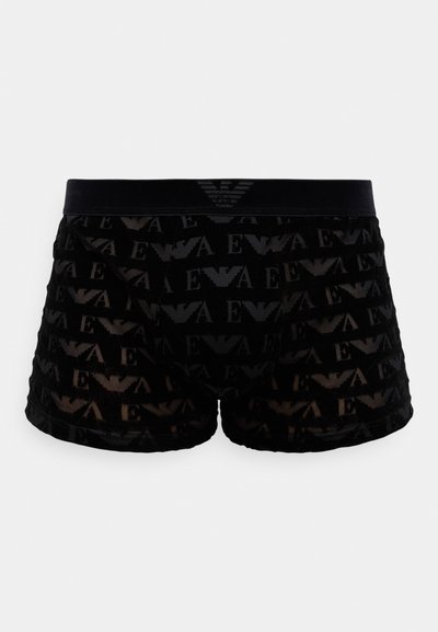 Boxers negros con una tela transparente y un patrón de logotipos en toda la superficie. La cinturilla es de color negro sólido con un detalle del logo sutil.