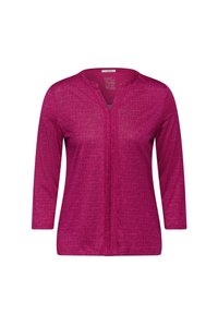 Magenta Langarmshirt mit V-Ausschnitt, das ein geometrisches Muster aufweist. Hergestellt aus einem strukturierten Stoff mit Vorderverschluss-Details.