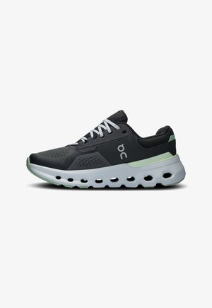 Athletic sneakers featuring a black mesh upper, white laces, and a cushioned sole with green accents and a textured, ventilated design.