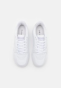 White leather sneakers with perforated toe cap, flat laces, and embossed logo on tongue. Smooth texture and rounded toe design.