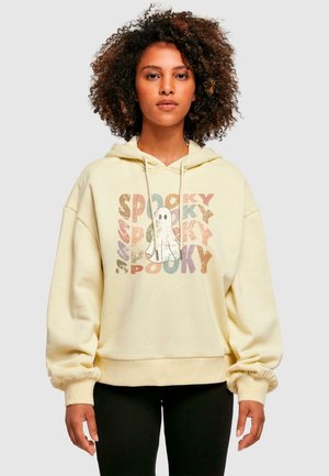 Yellow, oversized hoodie with drawstring hood. Features "SPOOKY" text in colorful, distressed print and graphic of a ghost on the front.