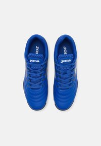 Blue sporty sneakers made of synthetic material, featuring a textured design, perforations, and black laces. Logo visible on the tongue.
