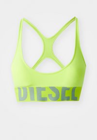 Neon grön sport-bh med korsad ryggdesign. Den elastiska banden har "DIESEL" i grå bokstäver. Slät yta, stretchigt material.