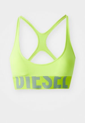 Soutien-gorge de sport vert néon avec un design dos croisé. La bande élastique présente "DIESEL" en lettres grises. Texture lisse, matériau extensible.