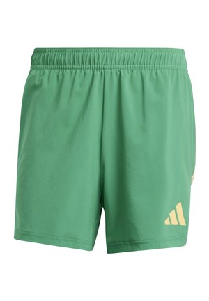Green athletic shorts made of soft fabric with an elastic waistband. Features a yellow Adidas logo on the lower right side.