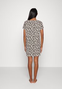 Short-sleeve leopard print nightdress in beige and black, featuring a relaxed fit and seamless neckline, falling above the knees.