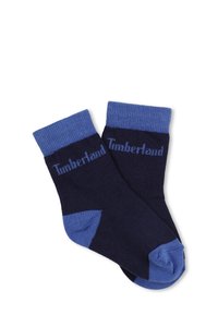 Calze di cotone blu navy con polsino a costine blu navy; accenti blu chiaro sul tallone e sulla punta; presenta il logo "Timberland" in blu chiaro.