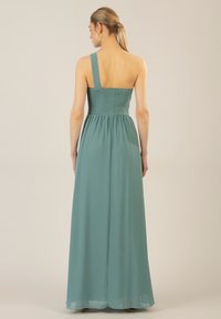 Langes Ein-Schulter-Kleid in Teal, mit einem gerafften Oberteil und einem fließenden Rock. Hergestellt aus leichtem Stoff mit einer glatten Textur.