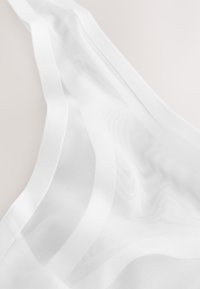 White sheer fabric with a mesh texture, featuring flowing drapes and a smooth surface. Overall lightweight and translucent design.