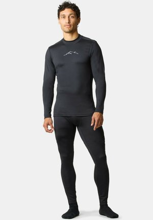 Svart termisk underställsset, långärmad topp med bergslogotyp, tight passform, slät textur och heltäckande leggings. Icke-reflekterande material.
