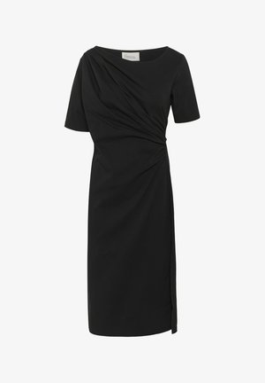 Musternis mustriga must särk, lühikeste varrukatega, ehitud esite detailiga, sirge lõikega ja külgde lõhikudega. Valmistatud siledast kangast klassikalise dekoltee stiiliga.