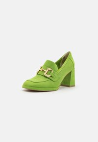 Chaussures à talons hauts en daim vert avec un bout carré, ornées d'une boucle en or décorative et d'un talon épais. Texture lisse, design moderne.