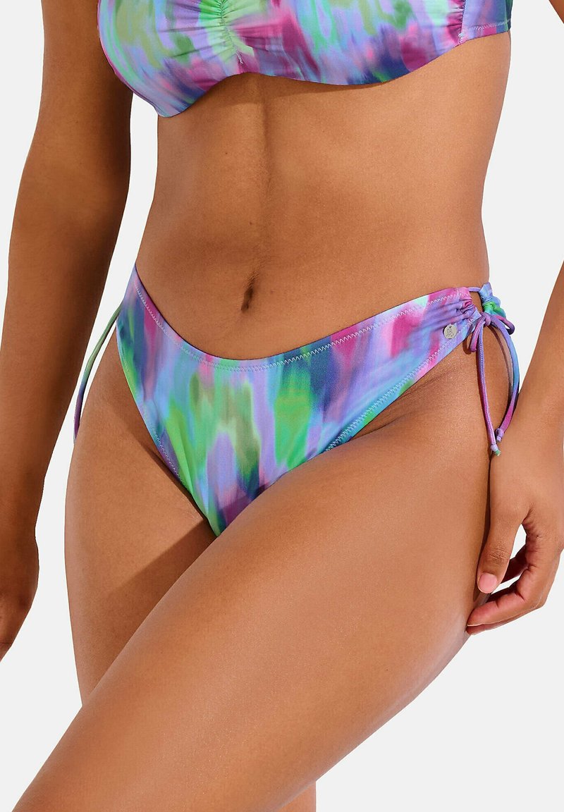 Bas de bikini multicolore en dégradé tie-dye de teintes violettes, vertes et roses. Comprend des liens latéraux réglables et un design échancré. Texture soyeuse.