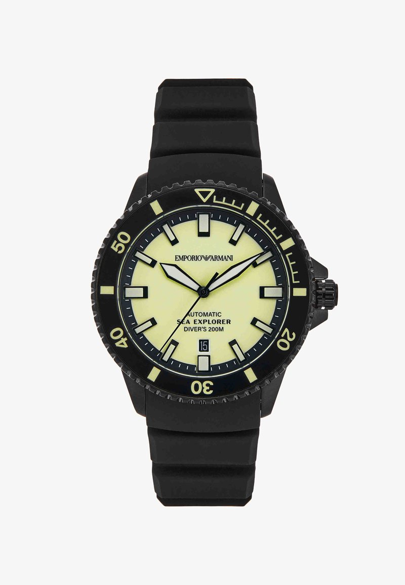 Černé potápěčské hodinky s luminiscenčním krémovým ciferníkem, výraznými hodinovými indexy, otočnou lunetou, okénkem s datem a černým gumovým řemínkem.