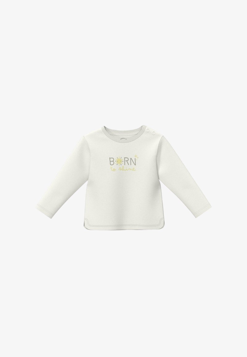 Chemise pour bébé à manches longues couleur crème avec boutons-pression à l'épaule et texte "Né pour briller" accompagné d'un graphique de soleil à l'avant.