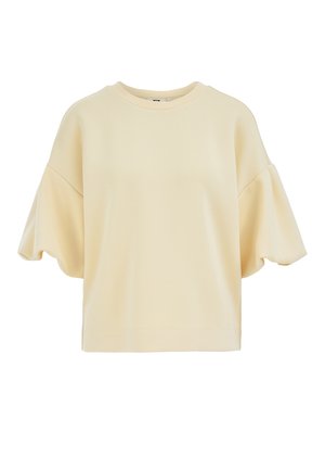 Sweat-shirt à manches courtes de couleur crème avec épaules tombantes et encolure ronde, présenté sur un fond blanc.