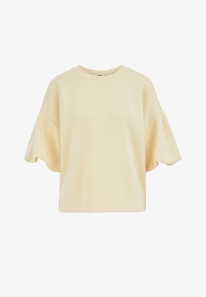 Krémově zbarvená mikina s krátkými rukávy, pokleslými rameny a kulatým výstřihem, zobrazena na bílém pozadí.