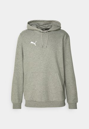 Grå bomullshoodie med kengurulomme, snorhette og hvit logo på brystet. Har ribbede mansjetter og hem for bedre passform.