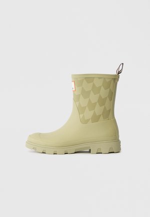 Light green rubber rain boot with a textured geometric pattern, high shaft, and a pull tab at the back for easy wear; rugged sole.