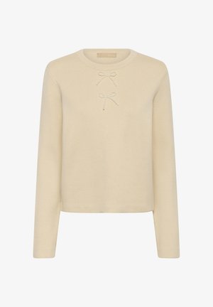 Kreemivärvi kudumiga särk ümmarguse kaelusega, pikkade varrukatega ja kahe helmestest paeltega kaunistusegaga ees. Pehme tekstuur, minimalistlik disain.