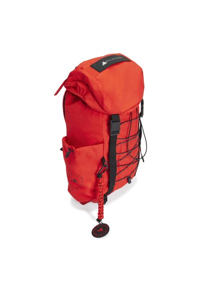 Red outdoor backpack with a top roll closure, black accents, bungee cord, and mesh side pocket. Durable fabric and textured surface details.
