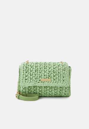 Woven green handbag with a textured finish, featuring a gold-tone hardware accent and a detachable strap for versatile carrying options.