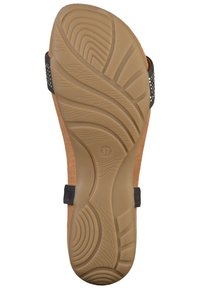 Tan korkfot sula med brun gummiyttersida. Funktioner en strukturerad design med ett vågmönster. Justerbar svart rem med silverdetaljer.